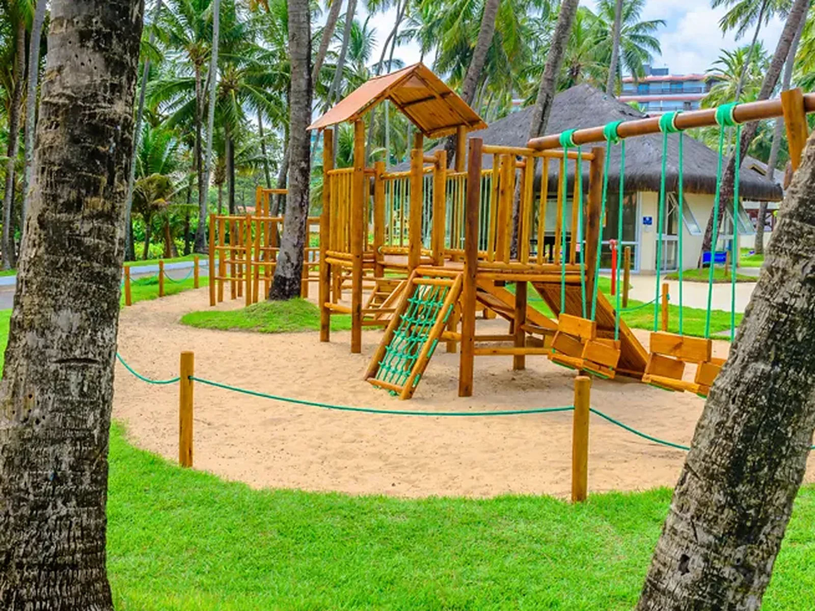 Wooden playground at the Jatiúca kids club, on the sand between the coconut trees